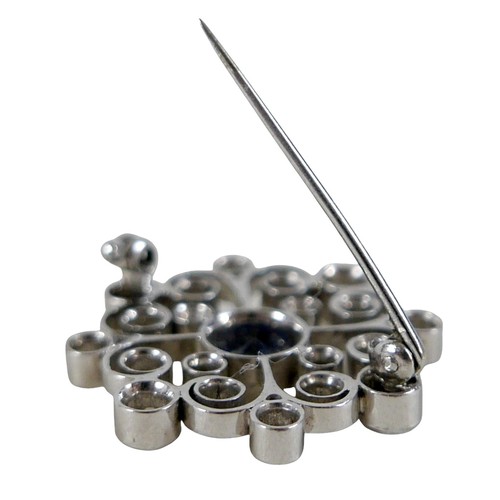 123 - A white metal sapphire and diamond flower head brooch the central sapphire approximately 1.0ct, surr... 