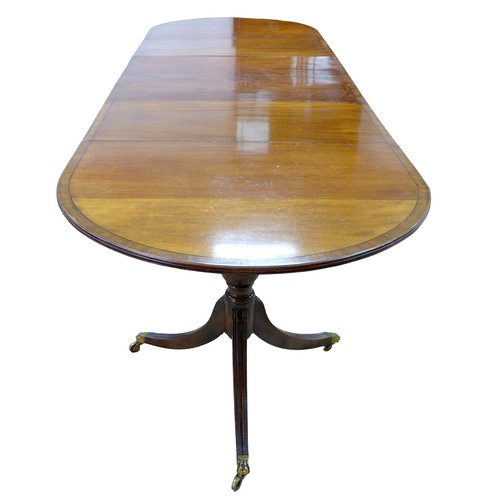 467 - A Regency style mahogany triple pedestal dining table, with cross banded decoration, raised on turne... 