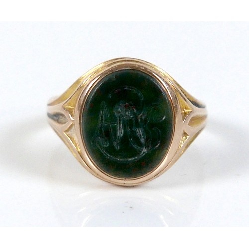 56 - An Edwardian yellow gold signet ring, inlaid with a green hard stone, rubbed hallmarks probably 15ct... 