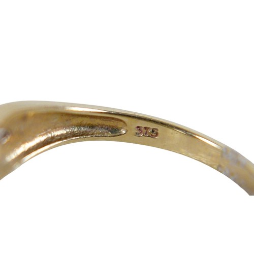 46 - Four 9ct gold rings, including a large pale blue oval cut stone ring with two small diamonds to its ... 