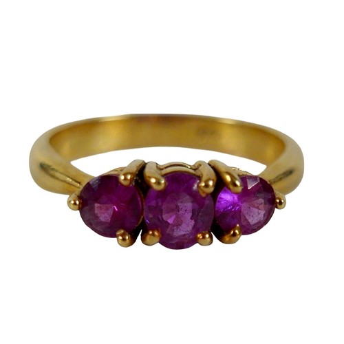 68 - An 18ct yellow gold pink sapphire three stone ring size P, head 23 by 14mm, 4.5g.