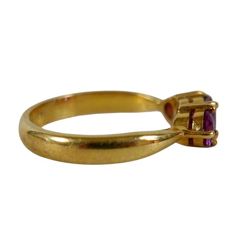 68 - An 18ct yellow gold pink sapphire three stone ring size P, head 23 by 14mm, 4.5g.