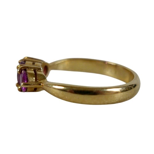 68 - An 18ct yellow gold pink sapphire three stone ring size P, head 23 by 14mm, 4.5g.