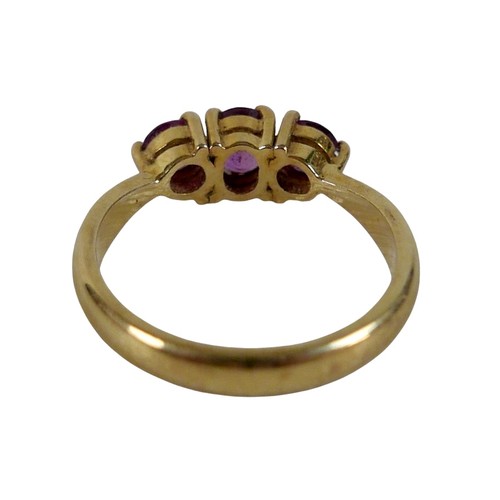 68 - An 18ct yellow gold pink sapphire three stone ring size P, head 23 by 14mm, 4.5g.