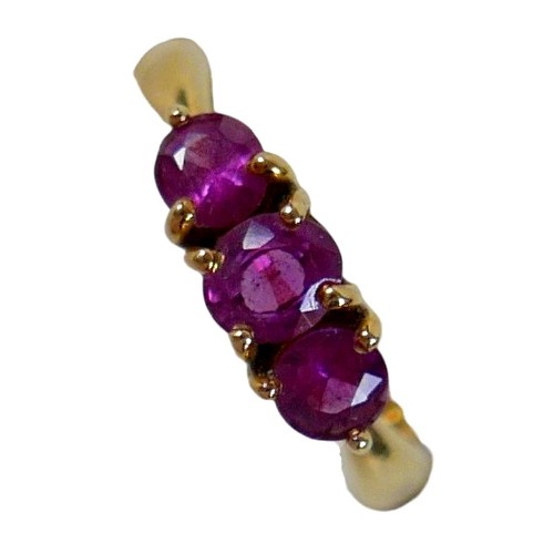 68 - An 18ct yellow gold pink sapphire three stone ring size P, head 23 by 14mm, 4.5g.