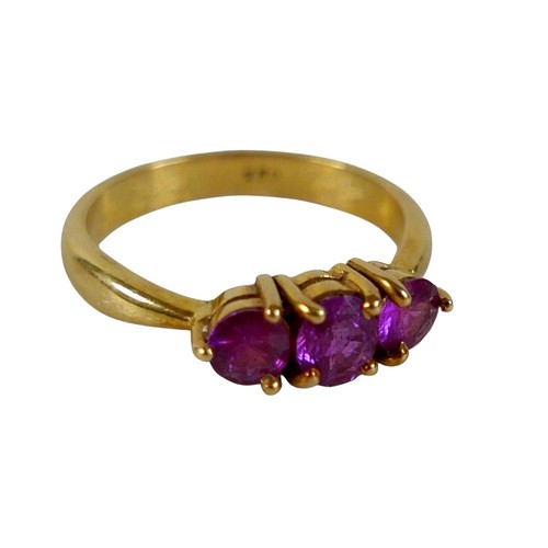 68 - An 18ct yellow gold pink sapphire three stone ring size P, head 23 by 14mm, 4.5g.