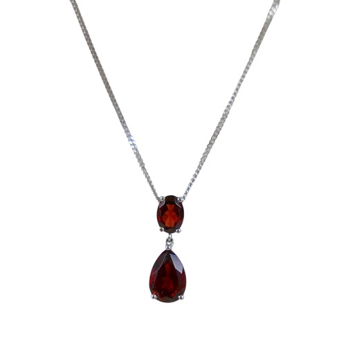 41 - A 9ct white gold garnet two stone pendant on a fine chain, pendant 30mm high, chain 46cm, 3.8g.