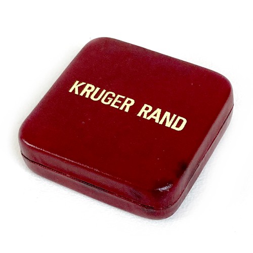 105 - A 22ct gold South African Krugerrand, 1974, 'Fyngoud 1oz Fine Gold', 32.5mm, 33.8g, in burgundy colo... 