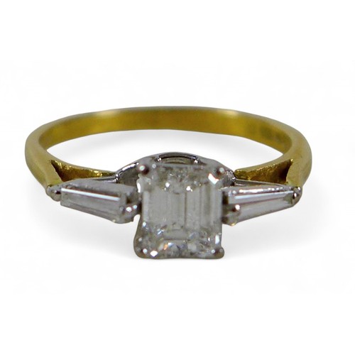 13 - An 18ct yellow gold and diamond ring, set with a emerald cut stone, approximately 0.54ct, 5.0 by 4.1... 