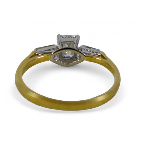 13 - An 18ct yellow gold and diamond ring, set with a emerald cut stone, approximately 0.54ct, 5.0 by 4.1... 