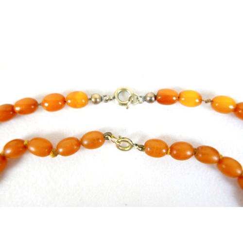 47 - Two butterscotch amber bead necklaces, both of forty five graduating beads, one with largest bead 22... 