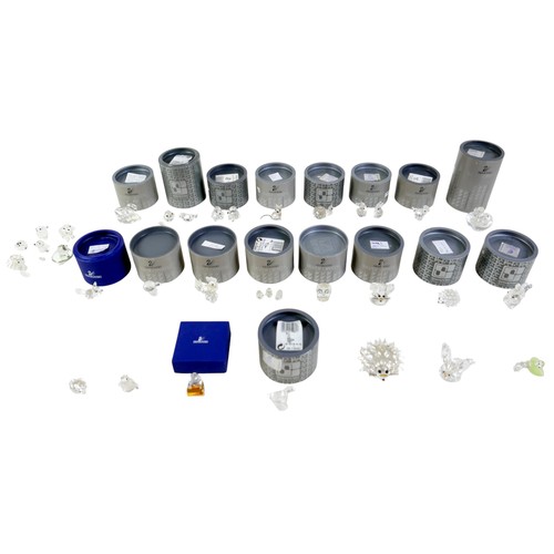 264 - A group of Swarovski crystal ornaments, including kiwi, owl, snail and large swan, with boxes and va... 