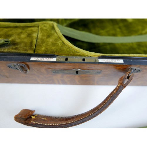 28 - An early / mid 20th century oak violin coffin case, by W. E. Hill & Sons, with fully fitted olive gr... 