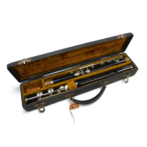 54 - An early 20th century ebony flute, by J. R. Lafleur & Sons, London, with hard fitted case.