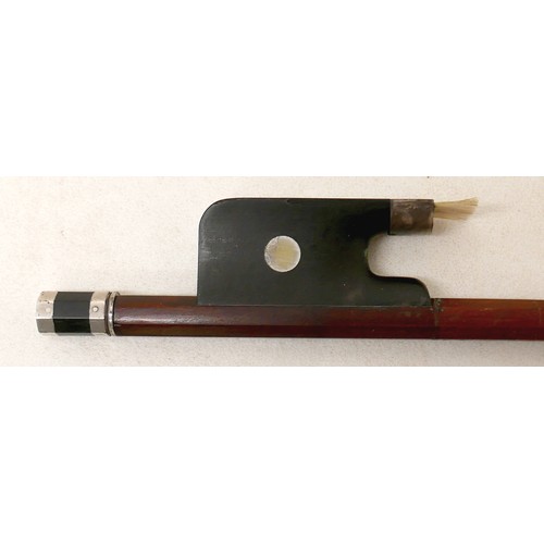27 - A violin bow, with ebonised and mother of pearl inlaid frog, 60g, 66cm long.