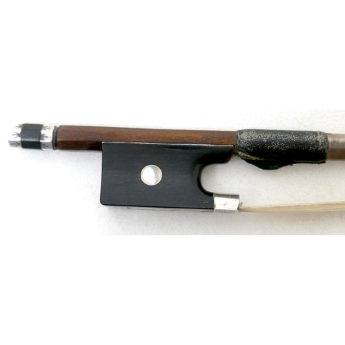 34 - A violin bow with engraved frog and ferrule, 60g, 73cm long.