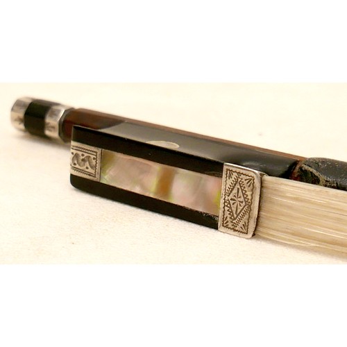 34 - A violin bow with engraved frog and ferrule, 60g, 73cm long.