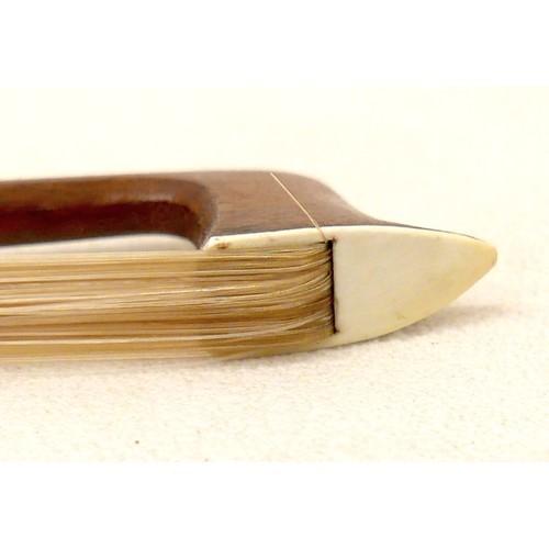 34 - A violin bow with engraved frog and ferrule, 60g, 73cm long.