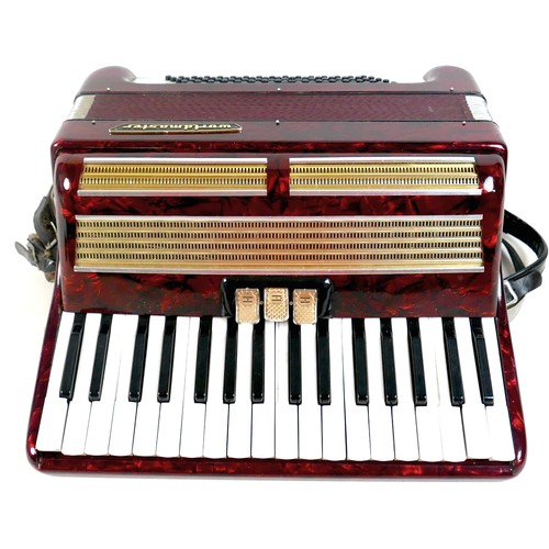 63 - A World Master accordion, red marbled finish, in carry case.