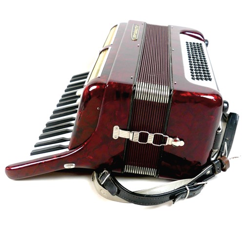 63 - A World Master accordion, red marbled finish, in carry case.