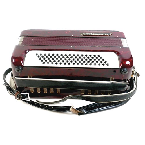 63 - A World Master accordion, red marbled finish, in carry case.