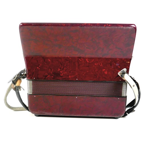 63 - A World Master accordion, red marbled finish, in carry case.