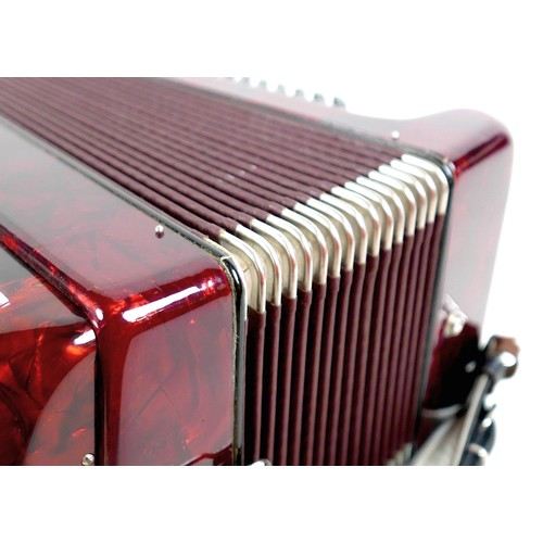 63 - A World Master accordion, red marbled finish, in carry case.