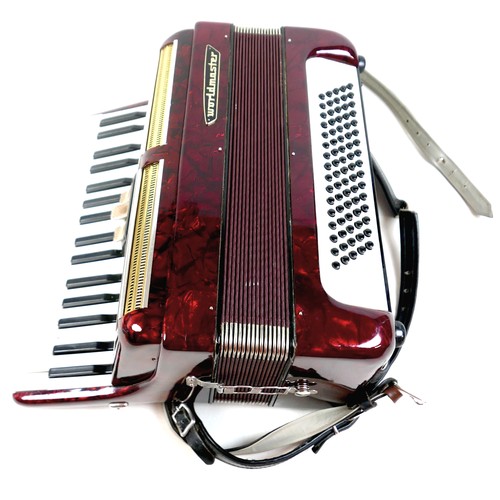 63 - A World Master accordion, red marbled finish, in carry case.