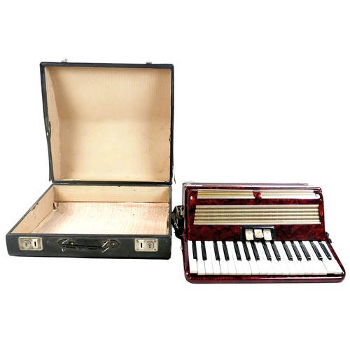 63 - A World Master accordion, red marbled finish, in carry case.