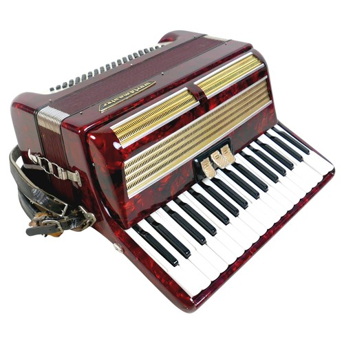 63 - A World Master accordion, red marbled finish, in carry case.