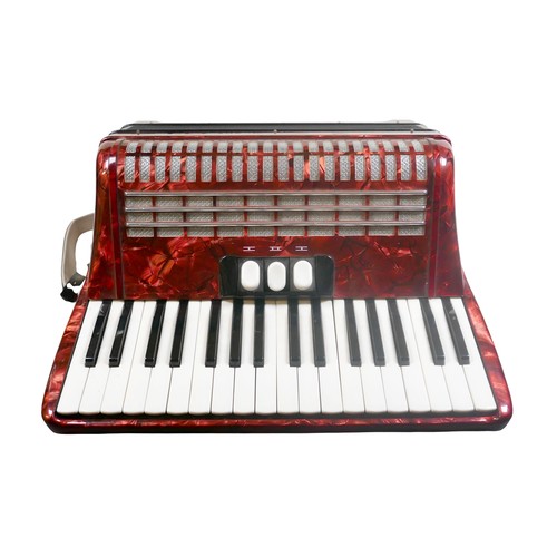 62 - A Hohner accordion, in red marbled finish.