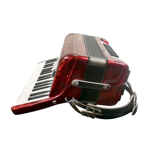 62 - A Hohner accordion, in red marbled finish.