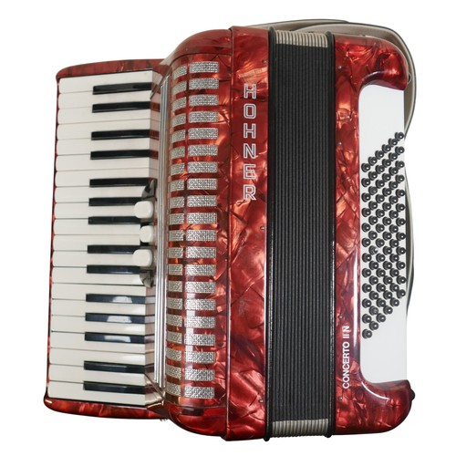 62 - A Hohner accordion, in red marbled finish.