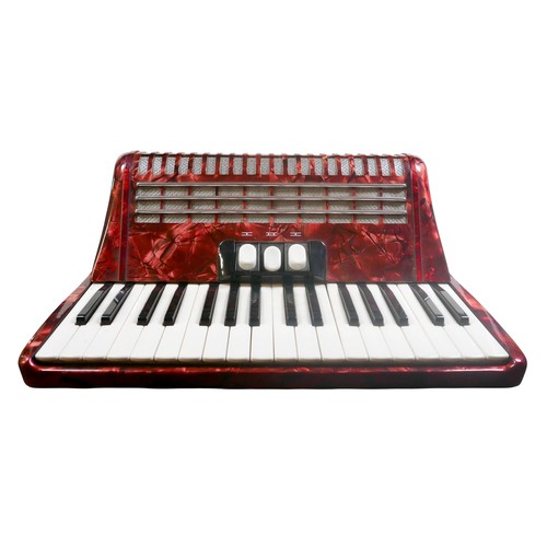 62 - A Hohner accordion, in red marbled finish.