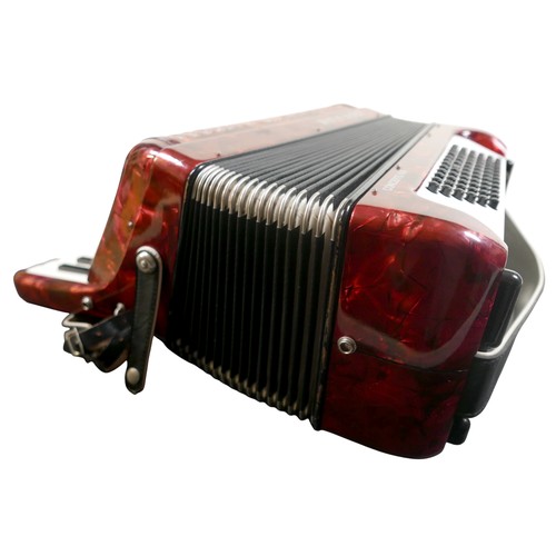 62 - A Hohner accordion, in red marbled finish.