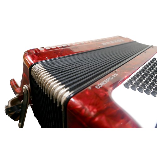62 - A Hohner accordion, in red marbled finish.