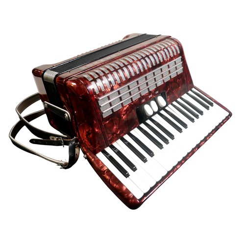 62 - A Hohner accordion, in red marbled finish.