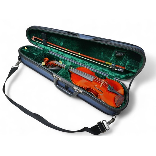 23 - A late 20th century German 1/4 size violin, by Herman, model Q017A, with bow and soft case, back 11