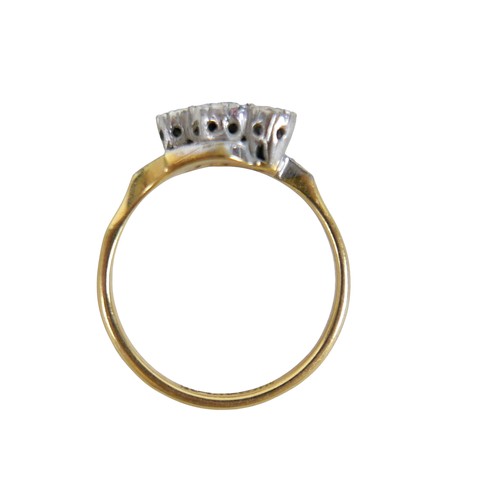 45 - An 18ct yellow gold and platinum three stone diamond crossover ring, illusion set, size N, 3.4g.