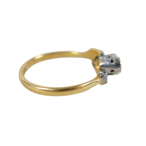 45 - An 18ct yellow gold and platinum three stone diamond crossover ring, illusion set, size N, 3.4g.