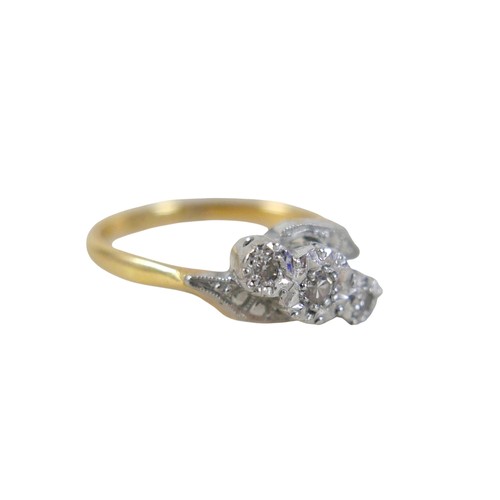 45 - An 18ct yellow gold and platinum three stone diamond crossover ring, illusion set, size N, 3.4g.
