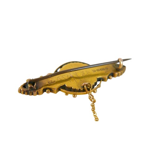 33 - A 9ct yellow gold brooch set with a small seed pearl, having a steel pin, 4.5cm wide, 3.8g.
