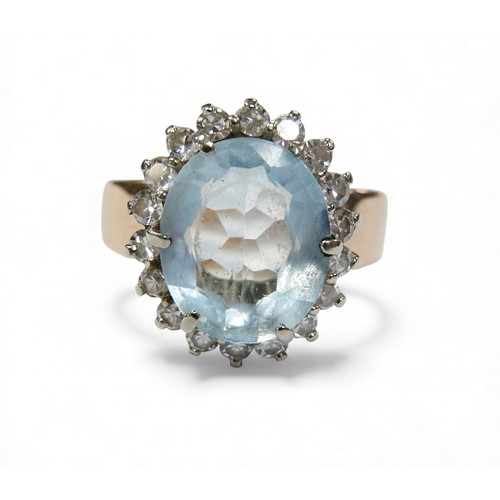 3 - A 14ct gold aquamarine and diamond daisy ring, oval cut aquamarine approximately 12 by 10mm, surroun... 
