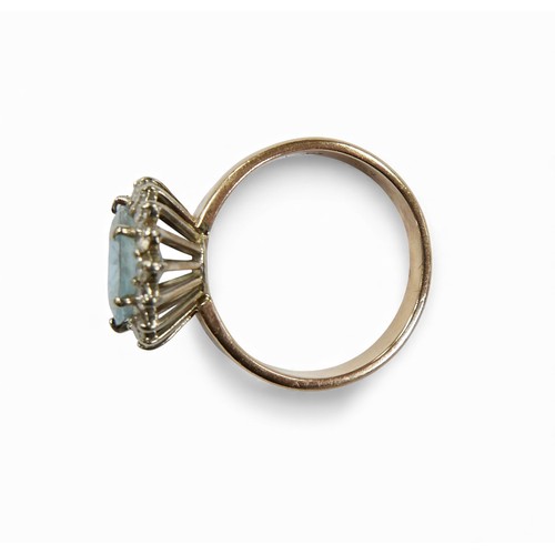 3 - A 14ct gold aquamarine and diamond daisy ring, oval cut aquamarine approximately 12 by 10mm, surroun... 