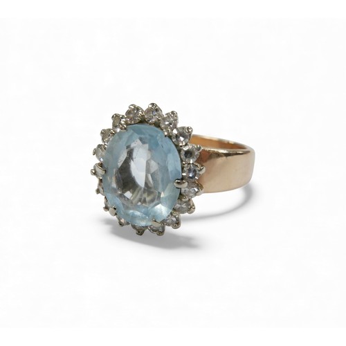3 - A 14ct gold aquamarine and diamond daisy ring, oval cut aquamarine approximately 12 by 10mm, surroun... 