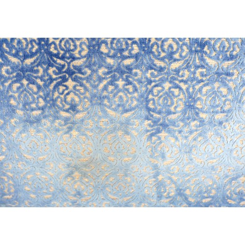 367 - An oversized double headboard, upholstered in blue jacquard fabric, with conforming wooden baton (Fr... 