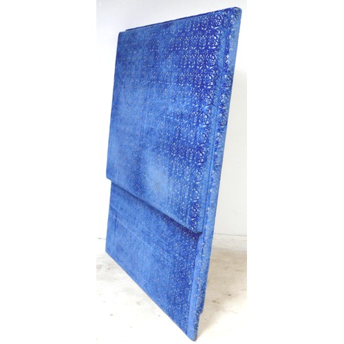 367 - An oversized double headboard, upholstered in blue jacquard fabric, with conforming wooden baton (Fr... 