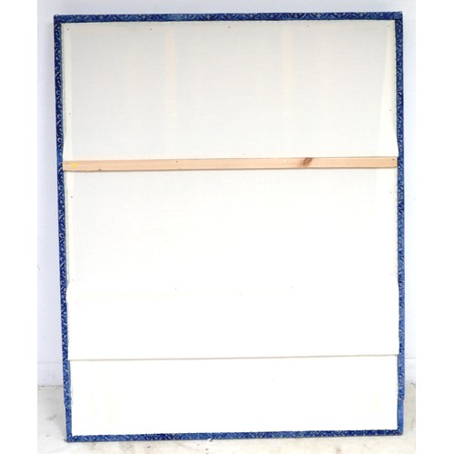 367 - An oversized double headboard, upholstered in blue jacquard fabric, with conforming wooden baton (Fr... 