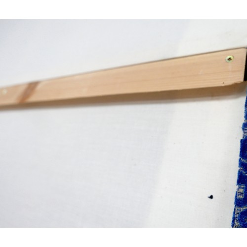 367 - An oversized double headboard, upholstered in blue jacquard fabric, with conforming wooden baton (Fr... 