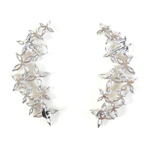 41 - A pair of silver Swarovski star burst Christmas party earrings, 54 by 22mm.